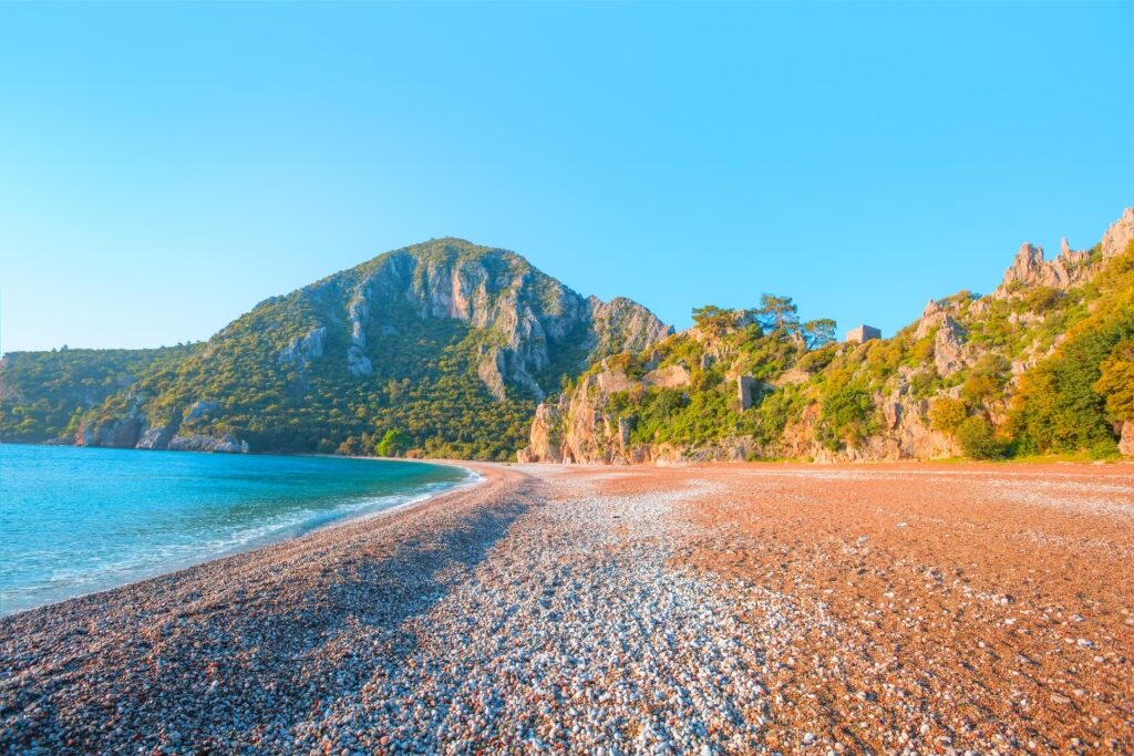 Peaceful Olympos Beach on the Turkish Riviera with turquoise sea and pebbled shore