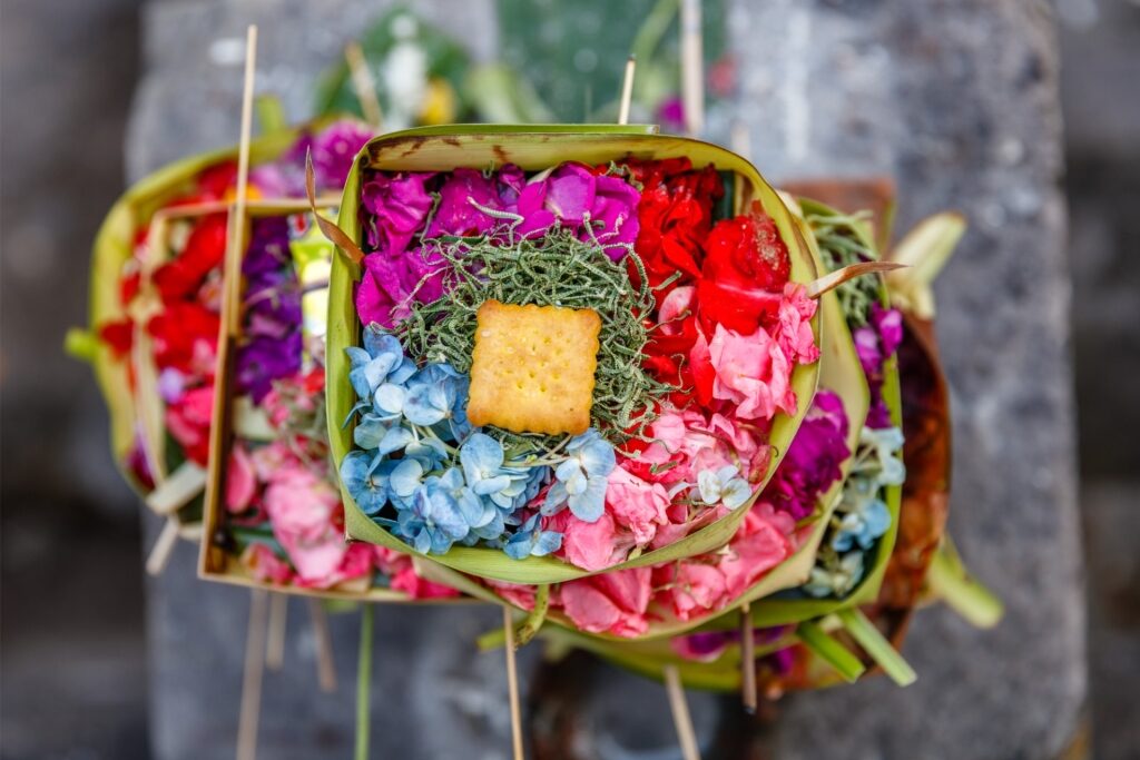 Balinese Canang Sari arranged with flowers and incense