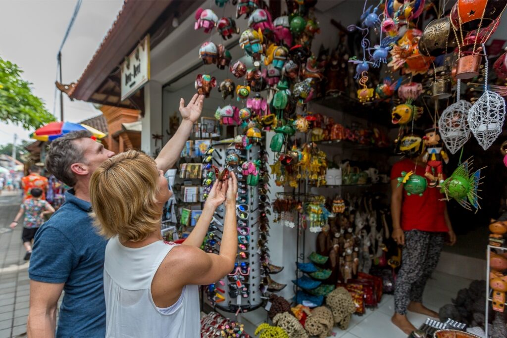 Tourist couple browsing stalls at Ubud Market in Bali, Indonesia