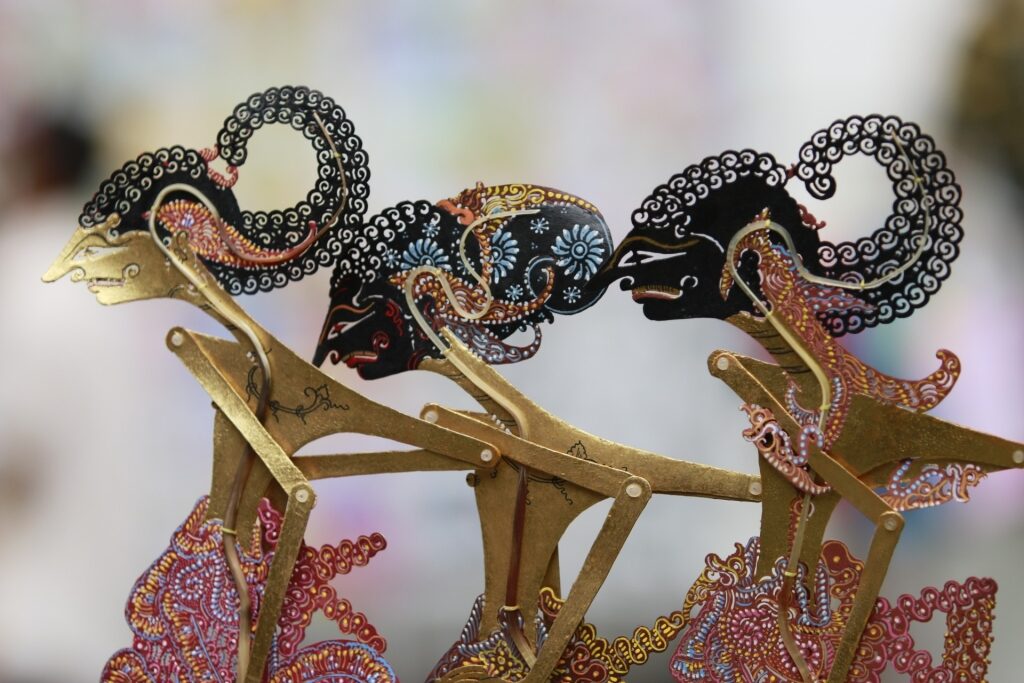 Close-up of intricately carved Wayang Kulit puppets used in Balinese performances