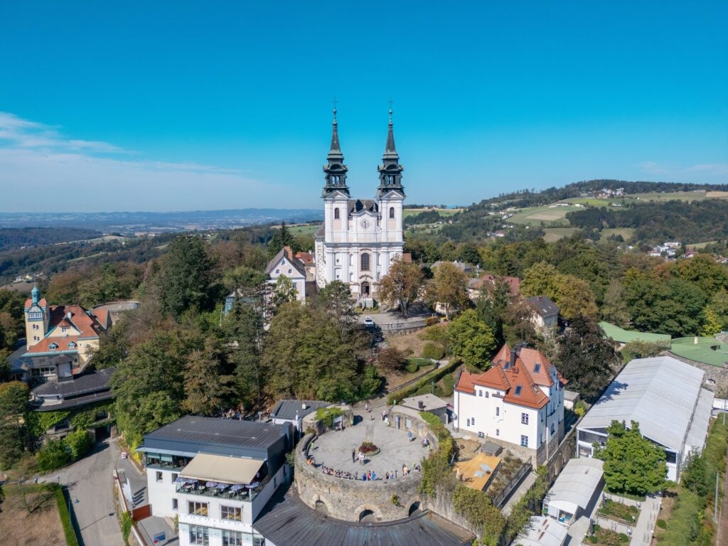 Pöstlingberg Hill with church tower rising above Linz