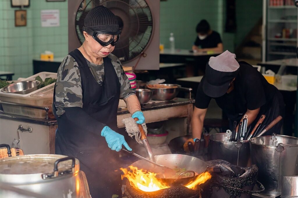 Bangkok street food vendor cooking signature meals at Jay Fai