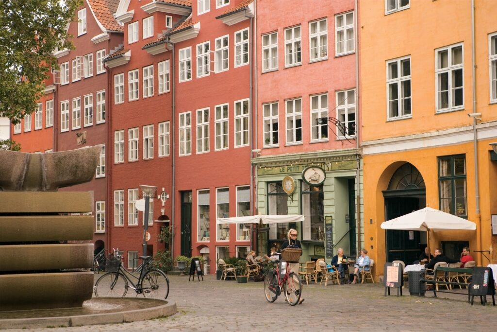 Vibrant Copenhagen street with cafes and colorful storefronts