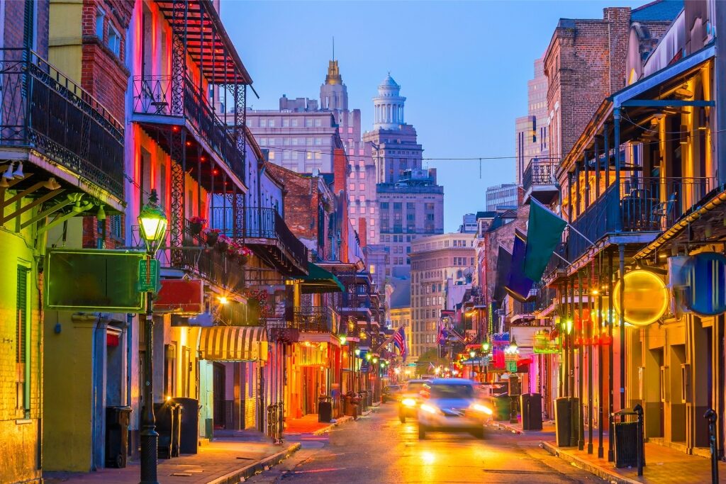 Night view of a brightly lit street in New Orleans, USA with historic buildings