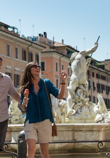 Tourists savoring gelato while sightseeing in Rome, Italy