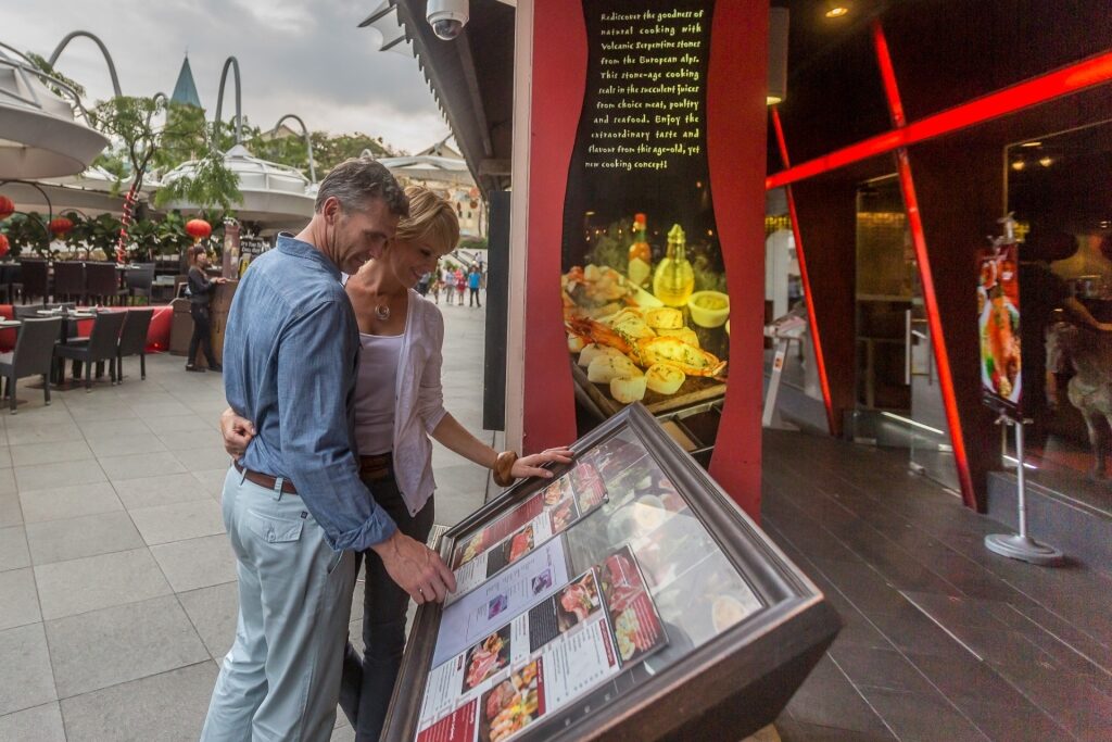 Travelers checking the menu at a restaurant in Singapore