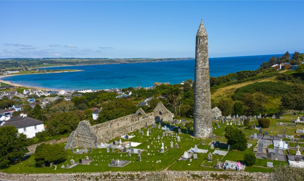 Aerial view of Ardmore Round Tower overlooking the coastal village of Ardmore