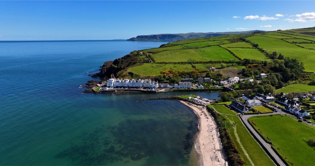 Aerial view of Cushendun townscape and sandy beach on the Northern Ireland coast