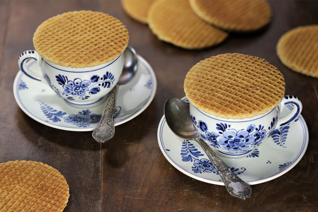 Fresh stroopwafels warming atop tea mugs for a classic Dutch treat