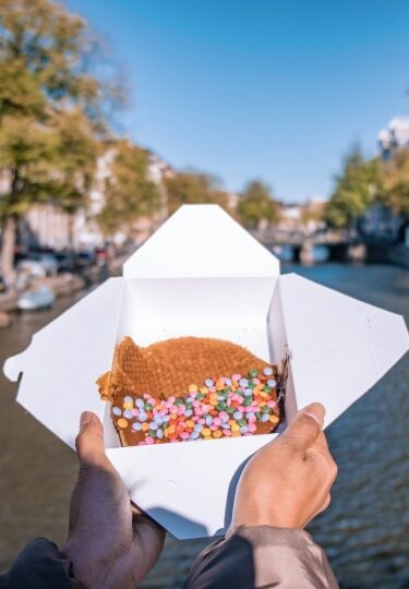 Best stroopwafels in Amsterdam - canal on the background