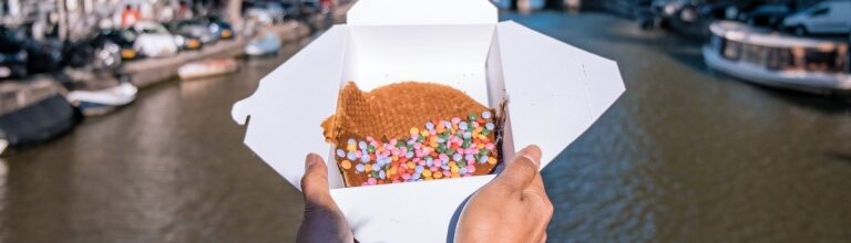 Best stroopwafels in Amsterdam - canal on the background