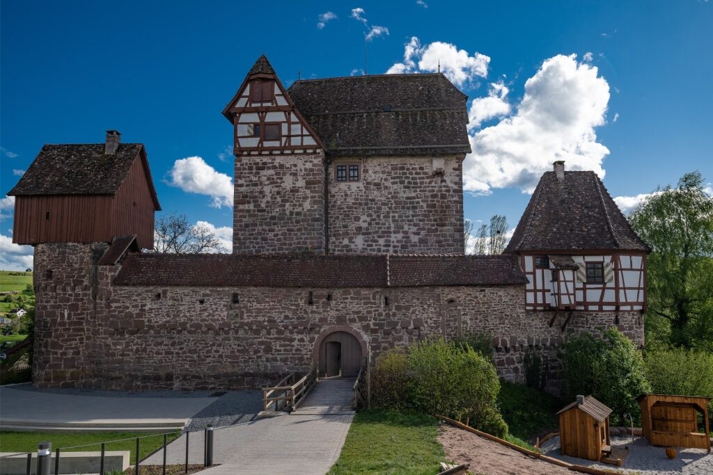 Exterior view of Altensteig Castle with stone walls and turrets in Germany