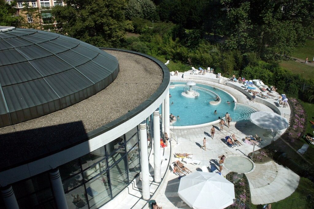 Bird’s-eye view of Caracalla Therme with tourists relaxing in the spa complex
