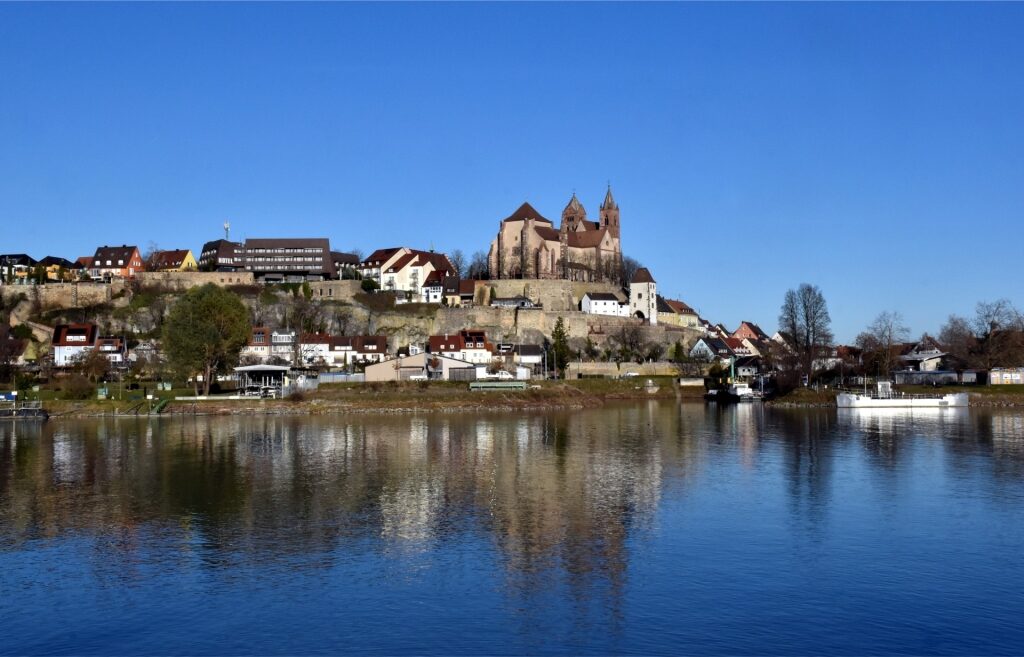 Breisach townscape along the Rhine with lush greenery and a vivid blue sky