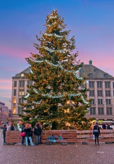 View of Dam Square in Amsterdam glowing with Christmas decorations