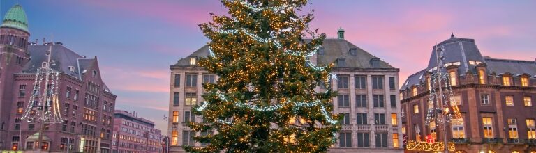 View of Dam Square in Amsterdam glowing with Christmas decorations