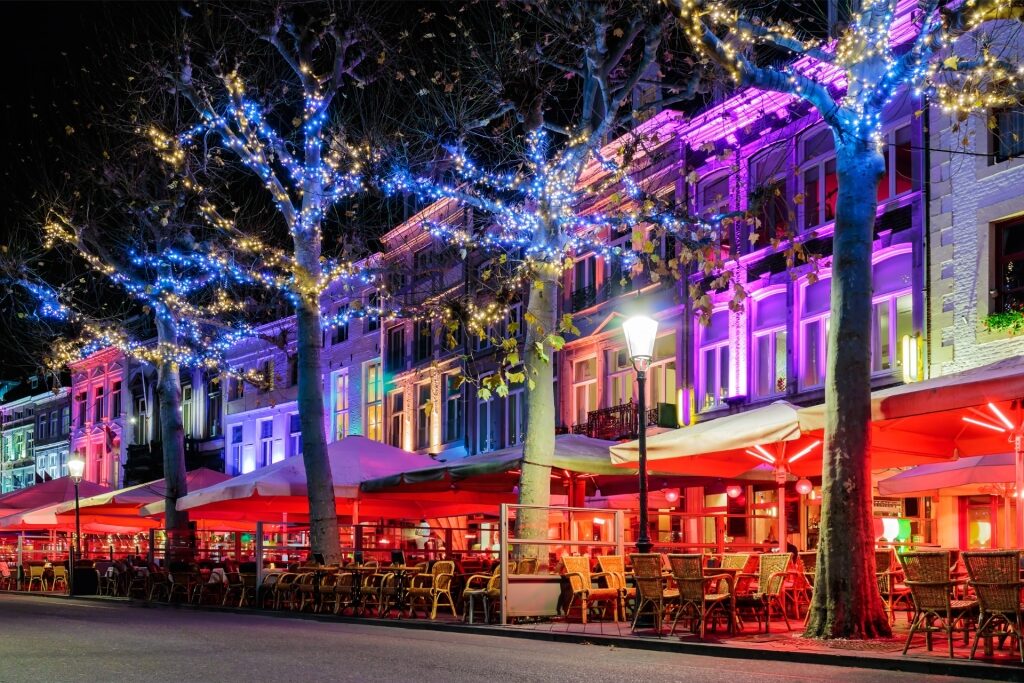 Festive Vrijthof Square with illuminated restaurants and holiday lights in Maastricht