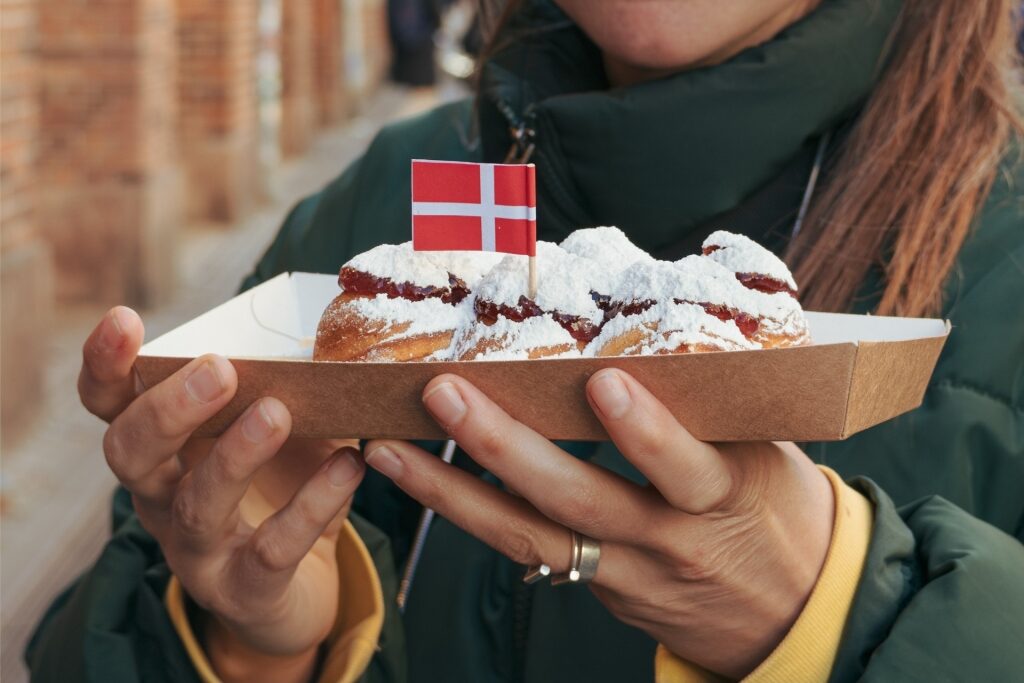 Tray of Danish Æbleskiver held by a young woman