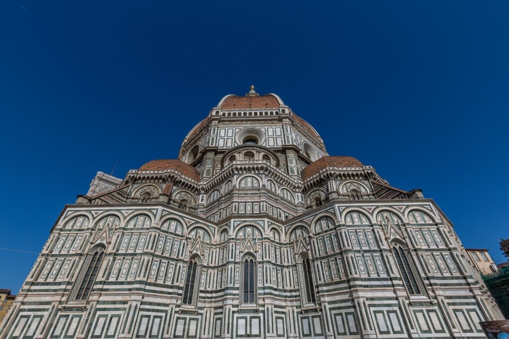 Exterior façade of Florence’s Cathedral of Santa Maria del Fiore under a clear blue sky