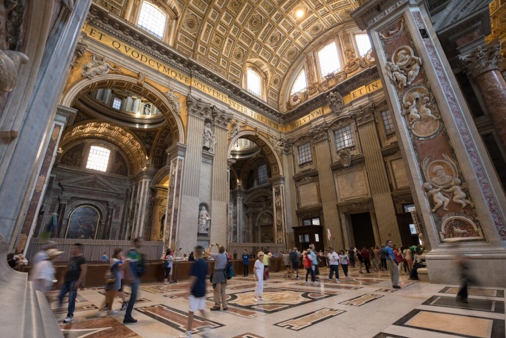 Interior view of St. Peter’s Basilica in Vatican City with tourists
