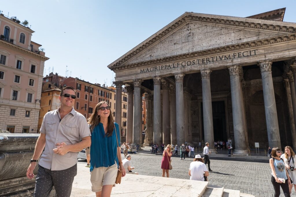 Tourist couple posing in front of the Pantheon in Rome
