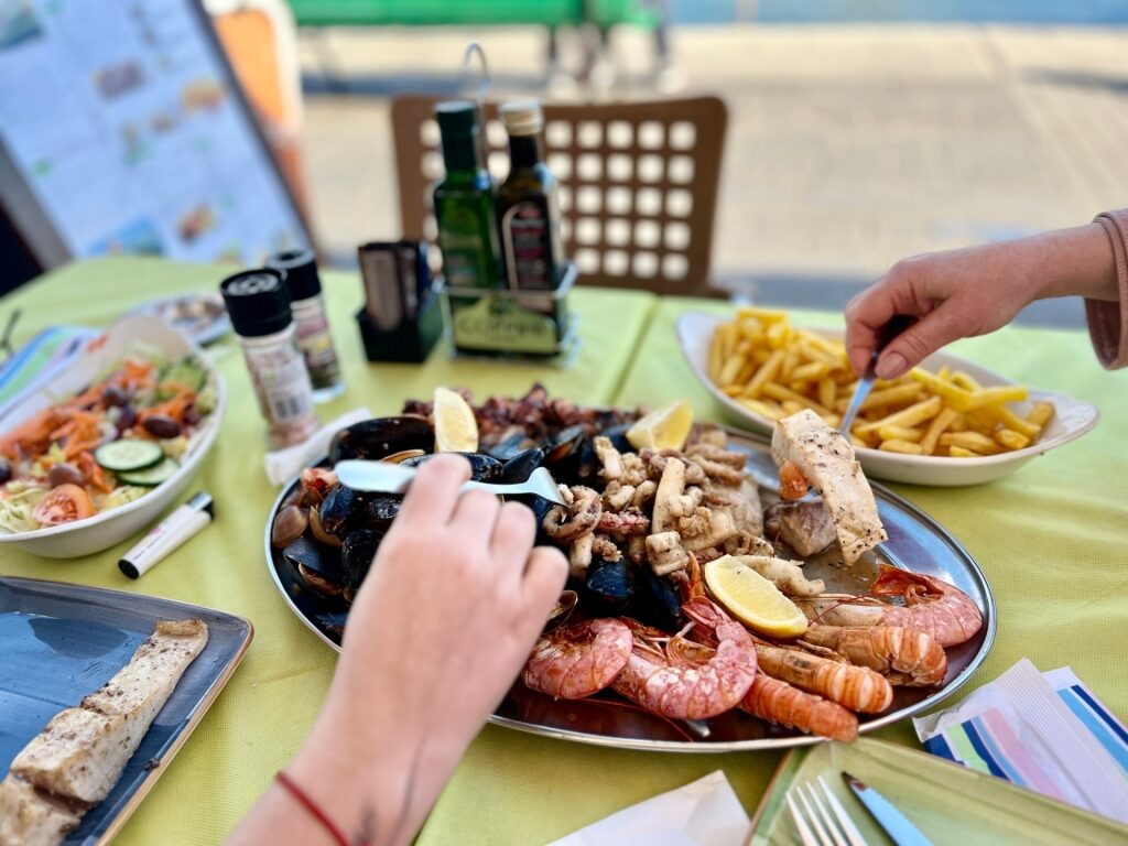 Maltese restaurant meal featuring local dishes like rabbit stew and seafood
