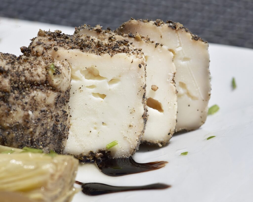Close-up of fresh ġbejniet, classic Maltese soft cheese