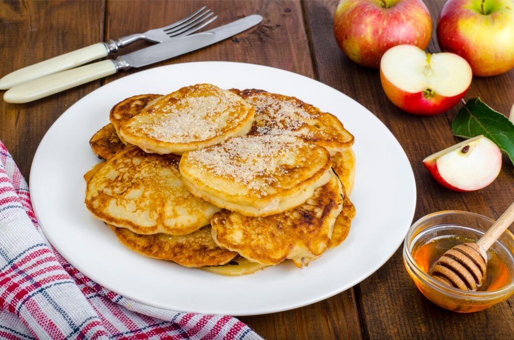 German dessert Apfelpfannkuchen featuring fluffy pancakes dusted with powdered sugar