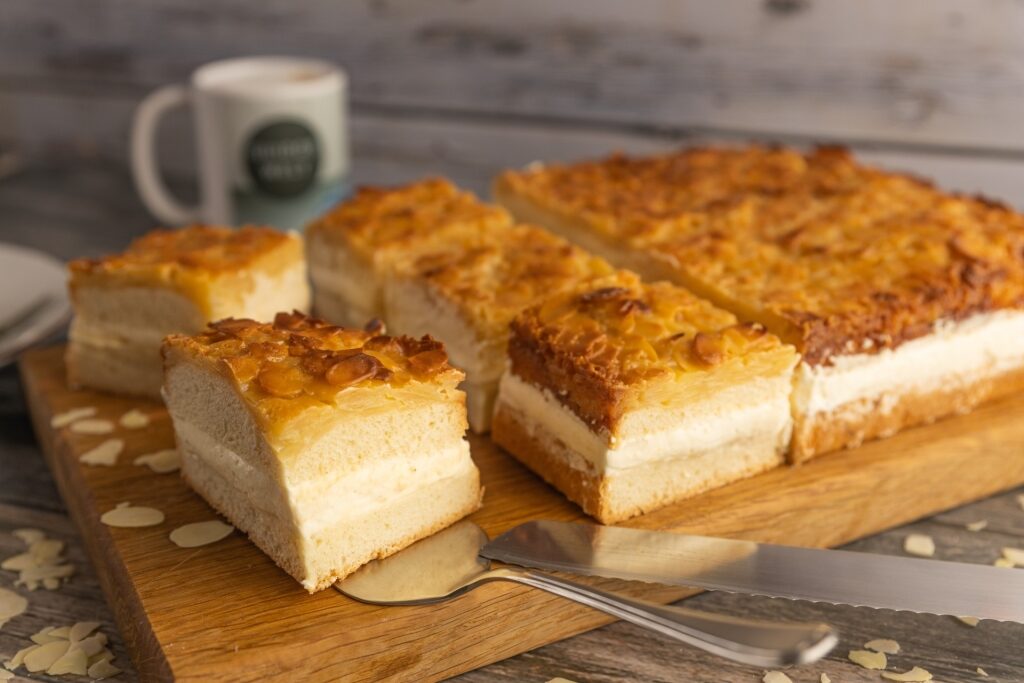 Classic Bienenstich honey cake with crunchy almonds and soft cream filling