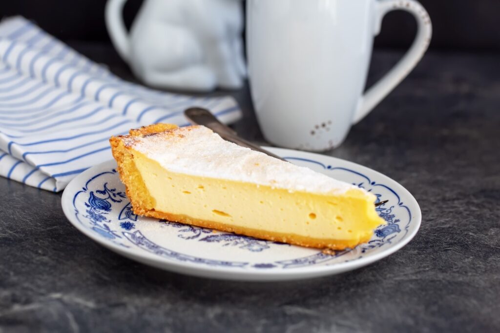 Slice of German Käsekuchen served on a plate