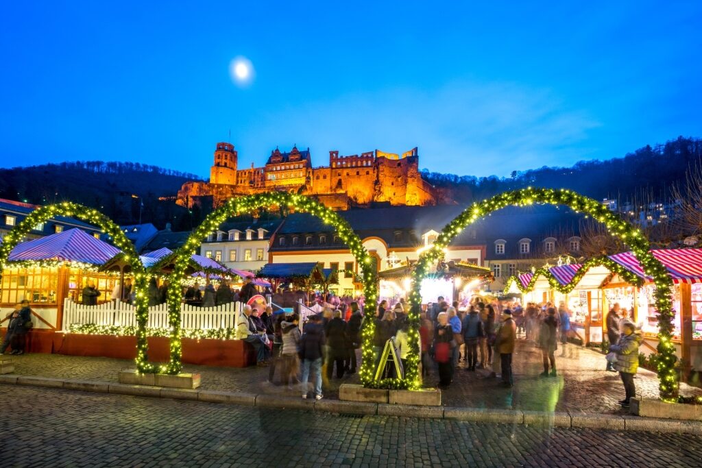 Heidelberg Christmas Market at night with the illuminated castle above