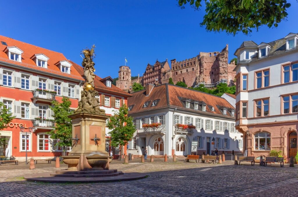 Madonna statue in Kornmarkt Square with Heidelberg Castle in the background