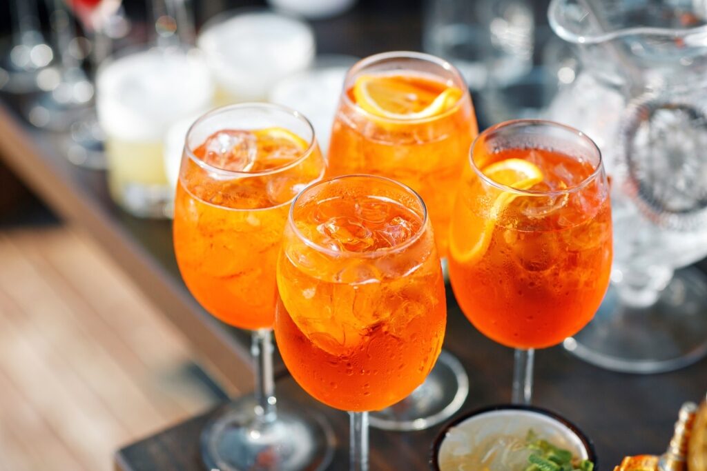 Glasses of Aperol Spritz Italian beverages served on a table