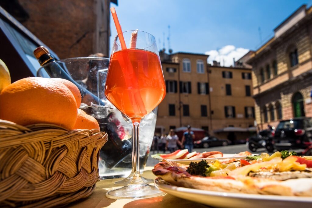 Italian beverage Aperol Spritz cocktail and Italian pizza served in Rome
