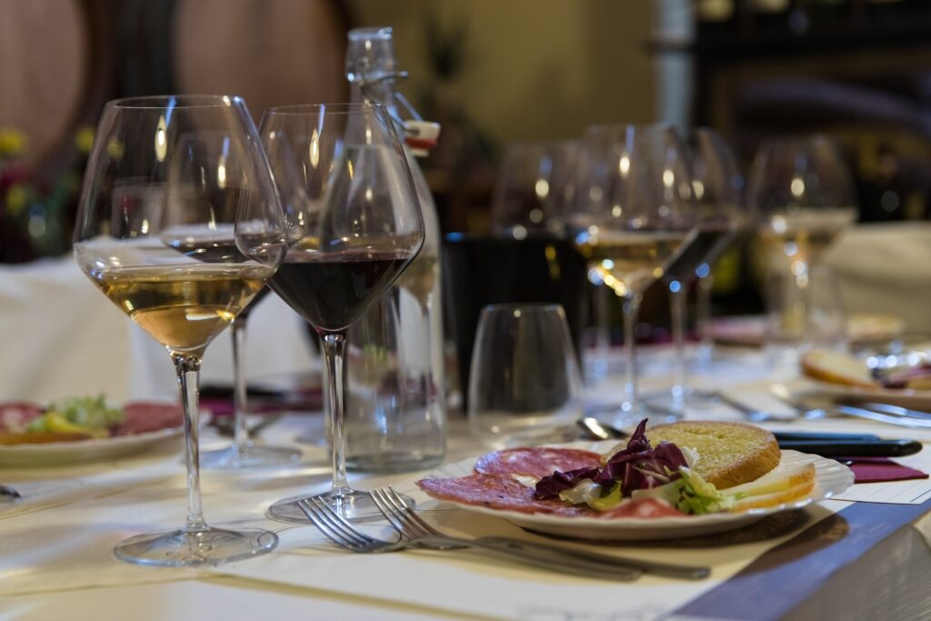Dinner table setup with glasses of Italian wine