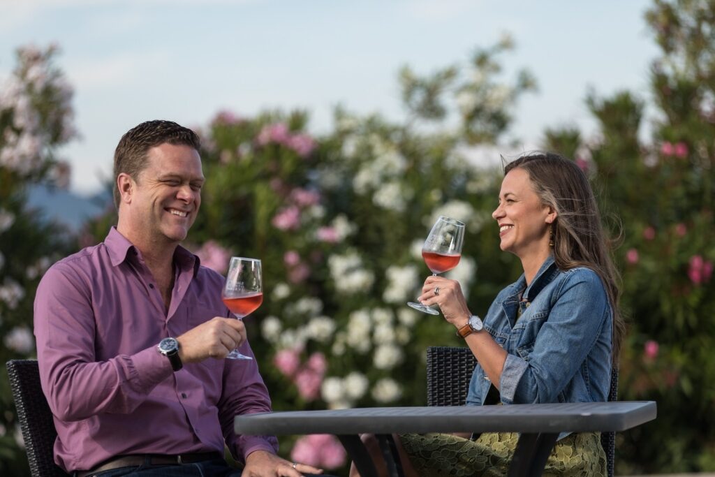 Tourist couple savoring wines at an Italian winery