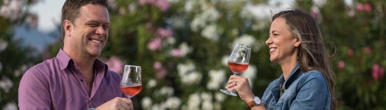 Tourist couple savoring wines at an Italian winery