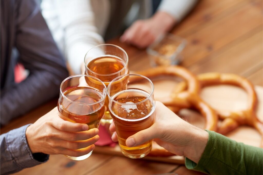 Friends clinking glasses of beer together in a celebratory toast