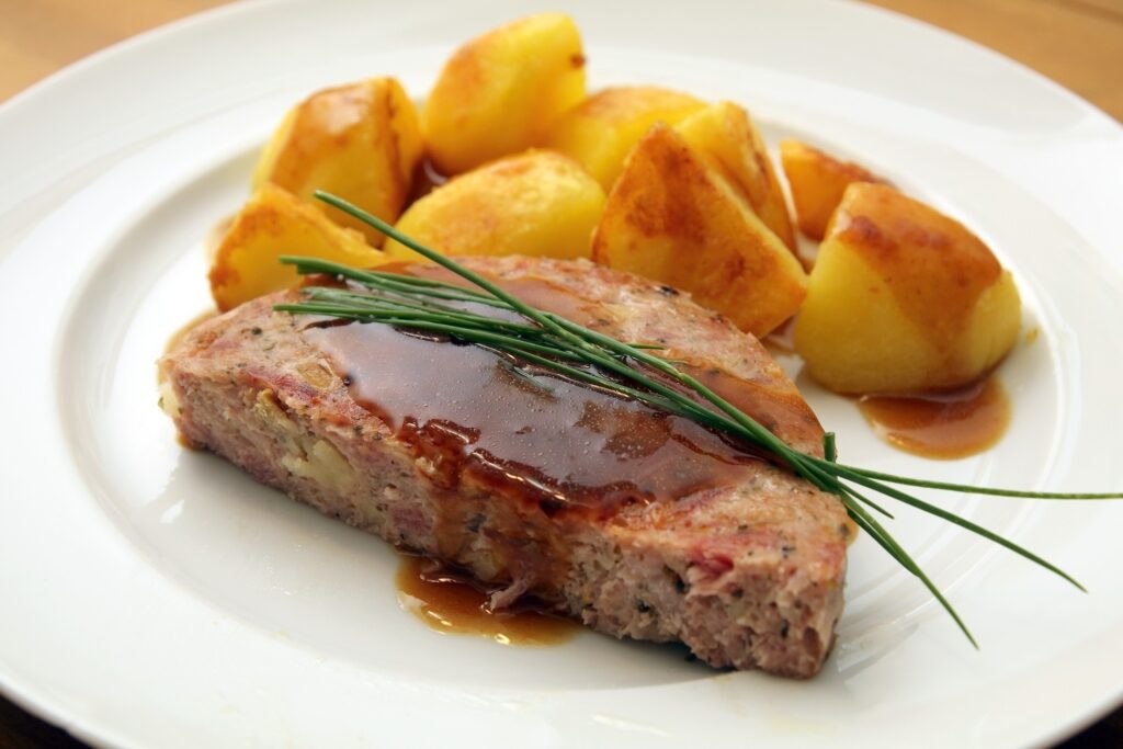Close-up of Pfälzer Saumagen served on a plate with potatoes