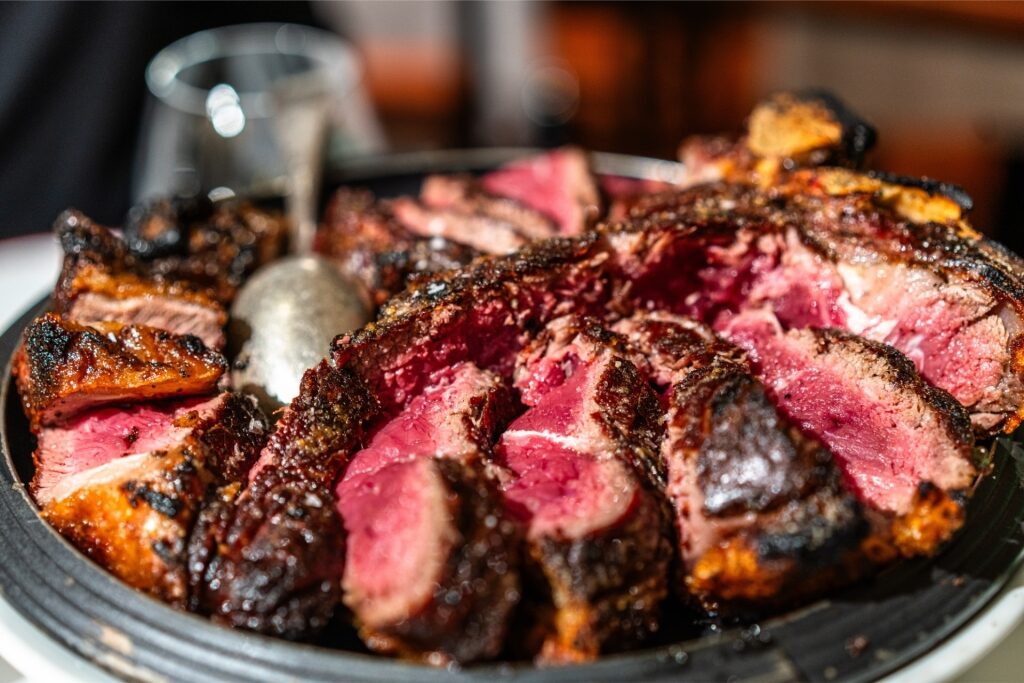 Close-up of a juicy Florentine steak (Bistecca alla Fiorentina) on a plate