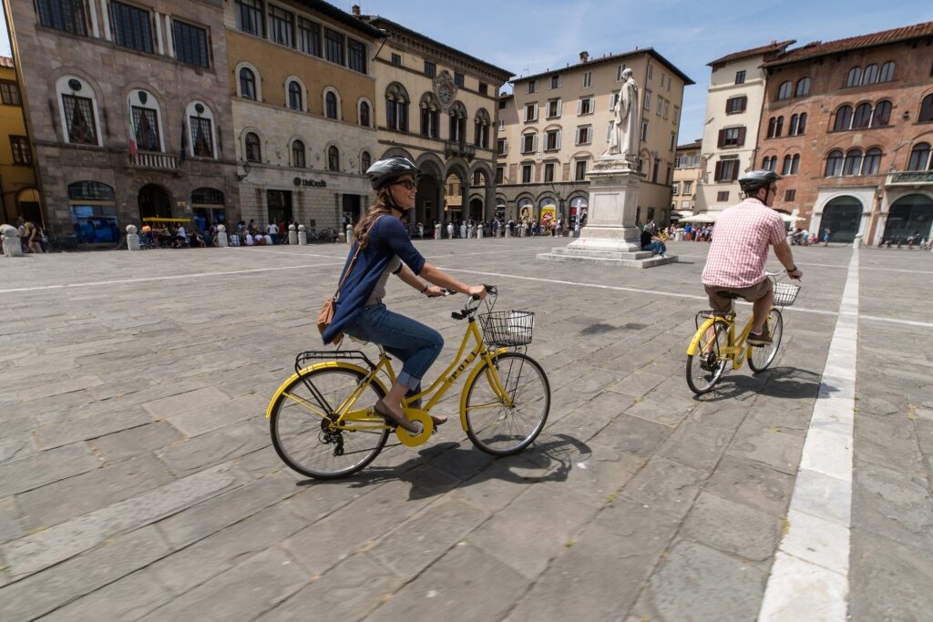 Tourists on bikes experiencing the old town of Lucca