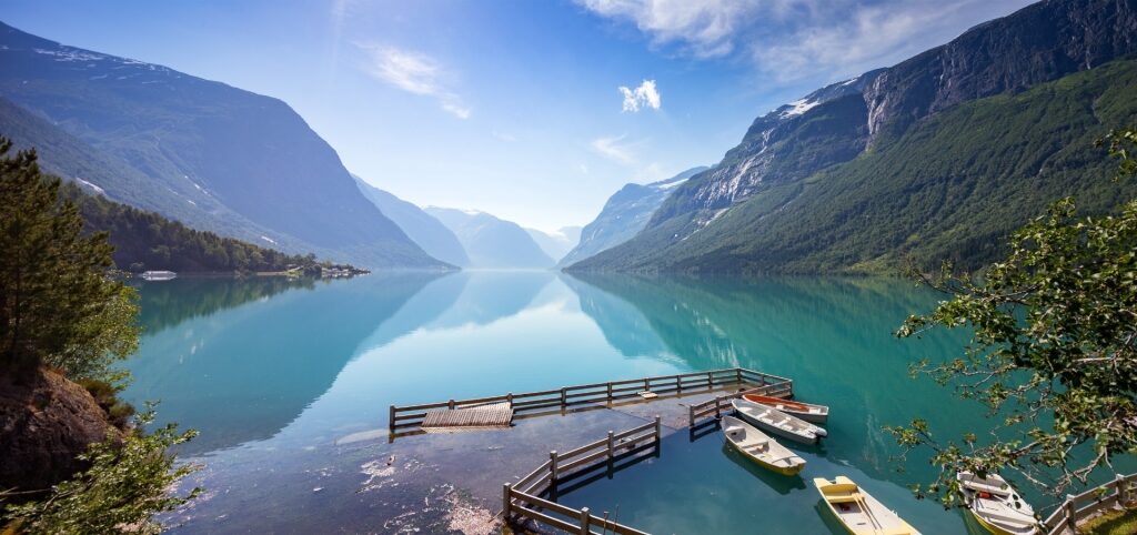 Scenic view of Lake Lovatnet surrounded by Norwegian mountains and greenery