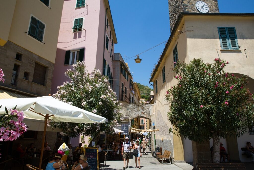 Narrow alleyway in Porto Venere, Italy lined with colorful Mediterranean buildings