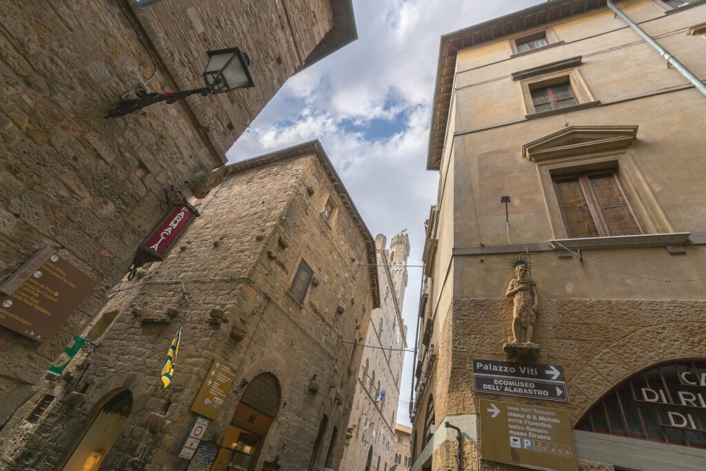 Looking up at medieval stone façades in the town of Volterra