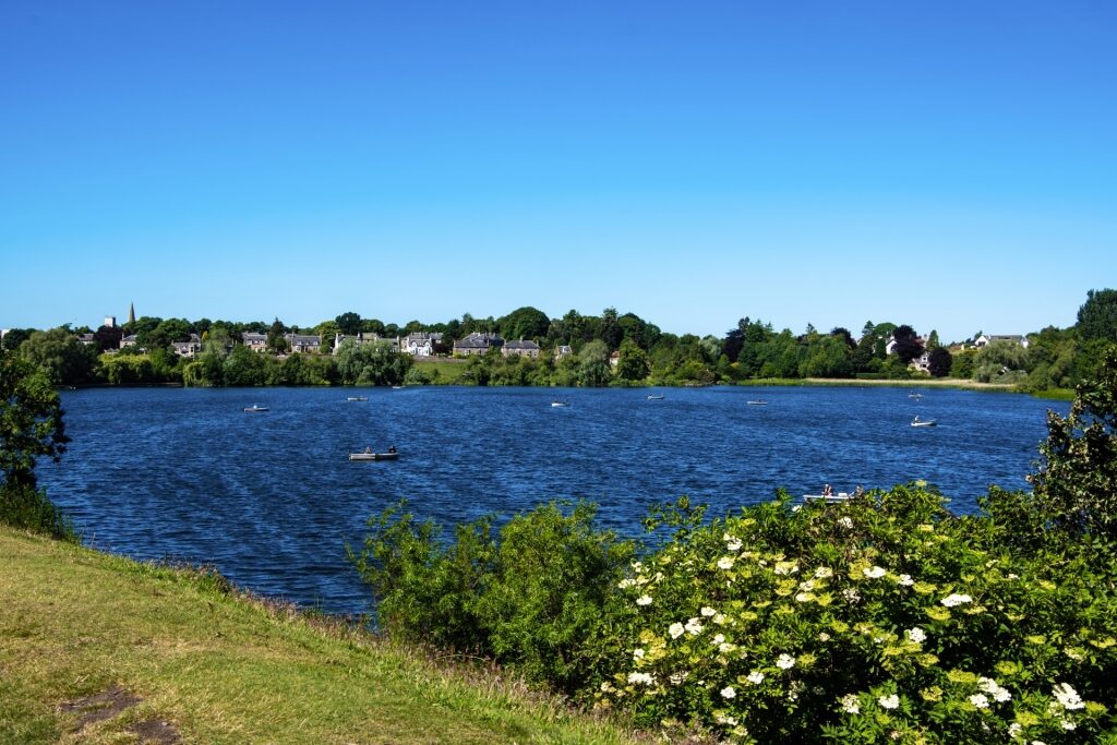 Scenic view of a lake near Linlithgow, Scotland surrounded by greenery