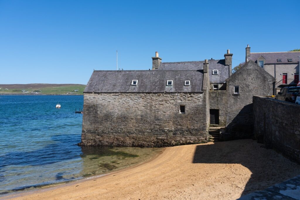 Traditional lodberry houses built directly on the shoreline in Lerwick
