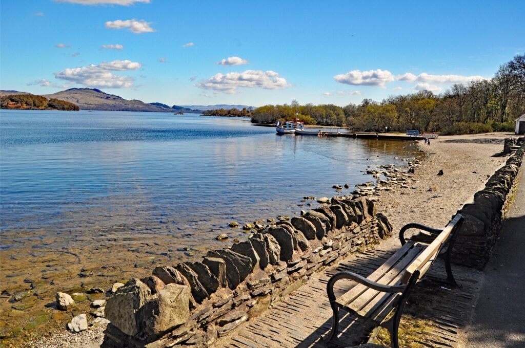 Beautiful Luss waterfront scene with a docked boat on Loch Lomond