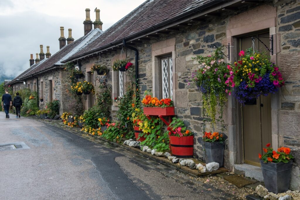 Flowers in front of traditional stone houses in Luss, Scotland