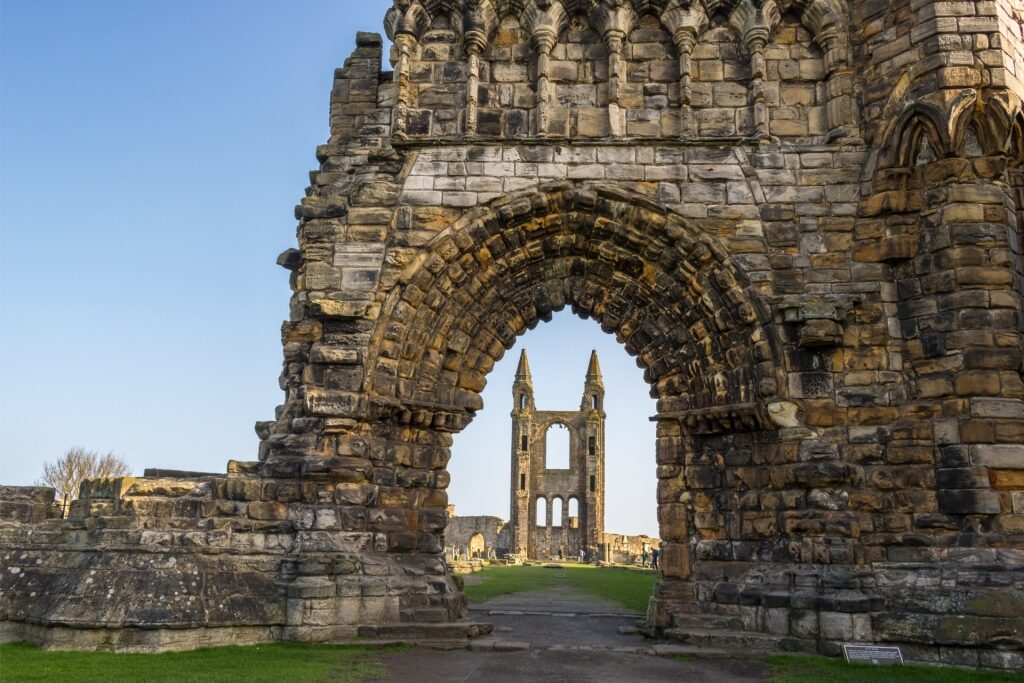 Historic St. Andrews Cathedral seen through stone archway framing the ruins