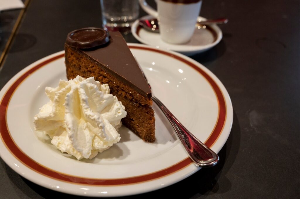 Served slice of Sachertorte with glossy chocolate topping